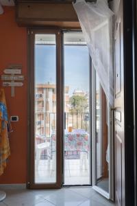 a sliding glass door with a view of a balcony at Residence Yellow in Rimini
