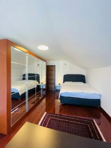 a bedroom with two beds and a large mirror at SOHO Pristina Kosovo in Pristina