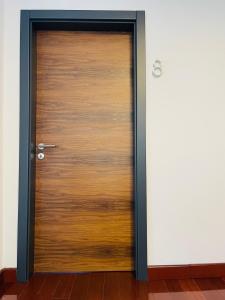 a wooden door in a room at SOHO Pristina Kosovo in Prishtinë