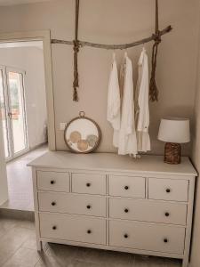 a dresser with a mirror on top of it at Villa Elia in Peroulades