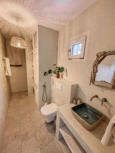 a bathroom with a toilet and a sink at Villa Elia in Peroulades