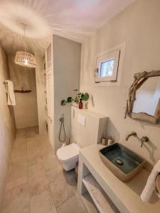 a bathroom with a toilet and a sink at Villa Elia in Peroulades +25 photos