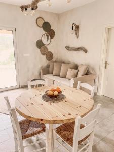 a wooden table and chairs in a living room at Villa Elia in Peroulades