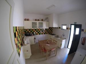 a kitchen with a table and a dining room at Casa do Cabril in Pedrógão Pequeno