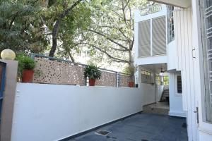 a white fence with potted plants on top of it at SHREE VILLA in Jaipur