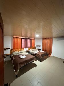 a large room with two beds in it at Blasina el valle in Valle de Anton