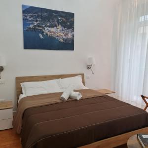 a bedroom with a bed with two towels on it at Mare Fuori B&B in Salerno