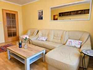 a living room with a couch and a coffee table at Sunny & Spacious, 10mins to Centre, Free parking, Quiet location, New Furniture, Balcony in Prague