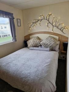 a bedroom with a large bed with lights on it at 35 Irby way in Skegness