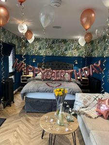 um quarto com uma cama com balões na parede em The Caswell bay hide out em Swansea