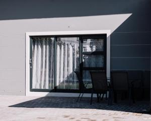 a table and chairs sitting in front of a window at Idiaz Beach House in Mossel Bay