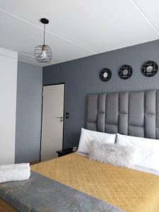 a bedroom with a large bed with a large headboard at Maneli 69 in Boksburg