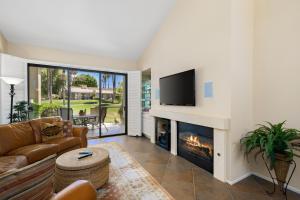 a living room with a couch and a fireplace at Palm Desert Oasis - With Beatiful Golf Courses in Palm Desert