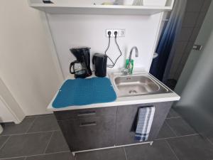 a small kitchen with a sink and a counter at BusinessQuartier Berlin in Berlin