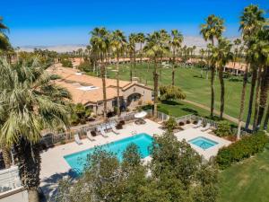 an aerial view of a resort with a pool and palm trees at Palm Desert Oasis - With Beatiful Golf Courses in Palm Desert