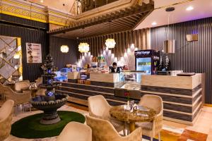 a restaurant with chairs and a table and a counter at ODST AL Madinah Hotel - فندق اودست المدينة in Medina