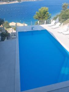 a swimming pool with a view of the water at Apartmani Barka in Neum
