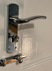 a metal door with a handle on a refrigerator at Cosy at Cumberland - Double room with shared bathroom in Dundonald