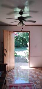 an open door to a room with a ceiling fan at Casa Cristy in Puerto Viejo