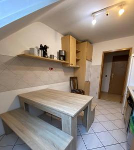 a kitchen with a wooden table in a room at Penthouse - 4-Zimmer und Terrasse in Karlsbad