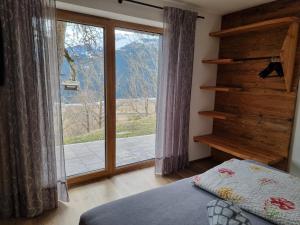 a bedroom with a window with a view of a mountain at Ferienwohnungen Zinzlerbauer in Uttendorf