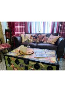 a living room with a couch and a coffee table at The Old Merchants House - The Highlands Room in Southampton