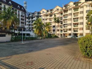 an empty street in front of a large building at 1-10Pax DOORSTEP TO BEACH, BBQ, STEAMBOAT, POOL, WATER SPORT in Port Dickson