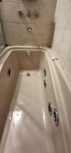 a white bath tub with water in it at Departamento Calle España - Vista Lago in San Carlos de Bariloche