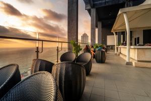 a balcony with chairs and a view of the ocean at Mövenpick Hotel Colombo in Colombo