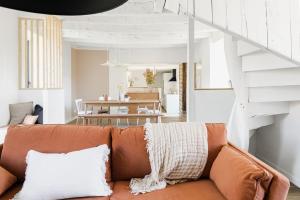 a living room with a couch and a table at Maison des 11 Écluses-Vue sur le Canal d'Ille-et-Rance in Hédé
