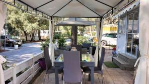 a table and chairs under an umbrella on a patio at Village l oasis in Puget-sur-Argens