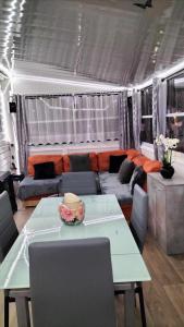 a living room with a table and a couch at Village l oasis in Puget-sur-Argens