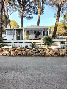 a white house with trees in the background at Village l oasis in Puget-sur-Argens