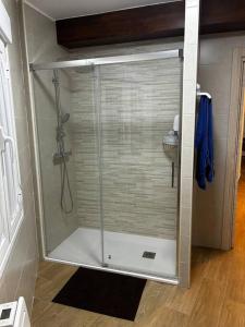 a shower with a glass door in a bathroom at El Coso in Santa Cruz de la Zarza