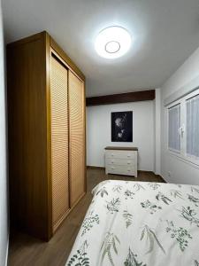 a bedroom with a bed and a dresser in it at El Coso in Santa Cruz de la Zarza