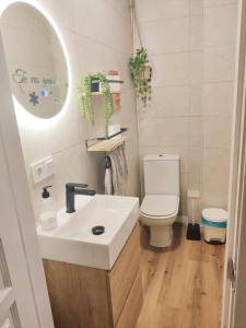 a bathroom with a white sink and a toilet at Lola´s winery house, andalusian patio in Granada