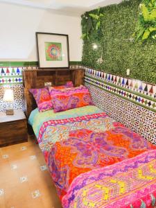 a bedroom with a bed and a green wall at Lola´s winery house, andalusian patio in Granada