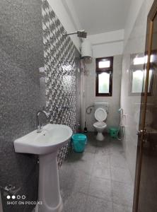uma casa de banho com um lavatório e um WC em Himali Homestay , Mirik em Mirik
