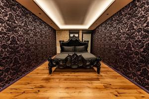 a bedroom with a bed with black wall paper at Sombres Pensées in Metz