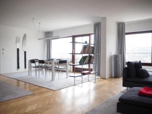 a living room with a dining room table and chairs at VILLA LANZO Linz in Linz