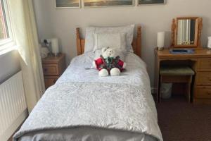 a teddy bear sitting on top of a bed at Bru Na Pairc B&B in Bantry