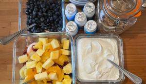 two plastic containers of food with fruit and whipped cream at Bru Na Pairc B&B in Bantry
