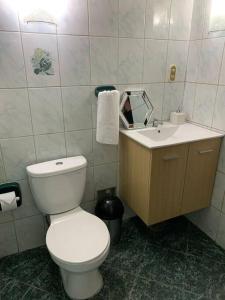 a bathroom with a white toilet and a sink at Céntrico y acogedor apartamento in Cajamarca