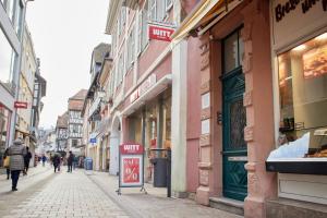 a city street with people walking down the street at UPPER ROOM Altstadt-Apartment im Herzen der Pfalz in Neustadt an der Weinstraße