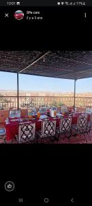 a restaurant with tables and chairs with a view of the desert at SAHARA EXPERTISE in Tagounite
