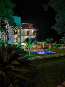 a house with a swimming pool at night at Hotel Pedasí Nature Paradise in Pedasí Town