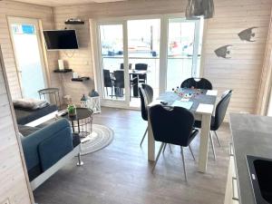a living room with a dining table and chairs at Hausboot ELLA- Huus & Meer in Burgstaaken