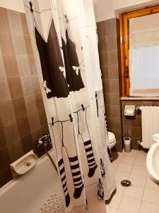 a bathroom with a shower curtain with socks on it at La casa di Bi in Caramanico Terme