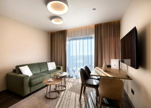 un soggiorno con divano e tavolo di Royal Village - Royal Views apartments a Malý Slavkov