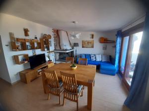 un salon avec une table et un canapé bleu dans l'établissement Cara a' mari, à Castelsardo